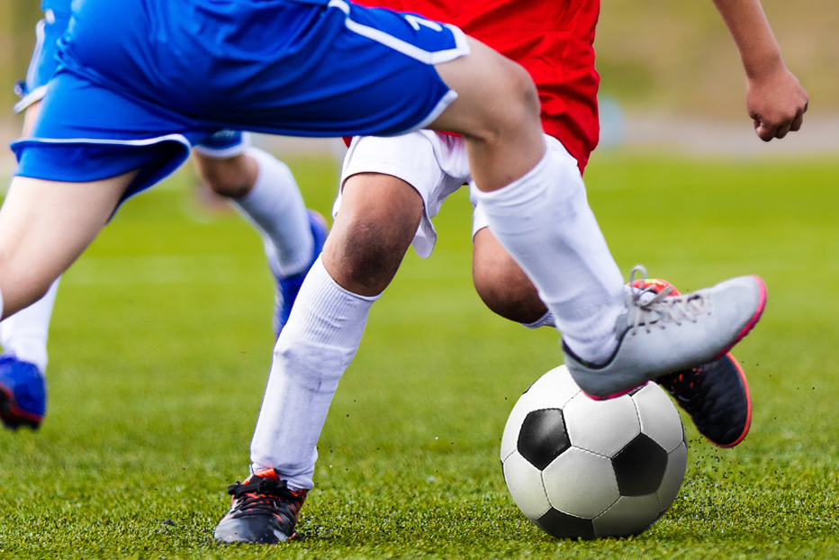 Footballers tackling the football