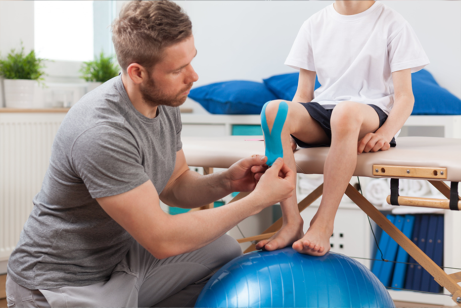 Osteopath looking at clients knee Osteopath looking at clients knee